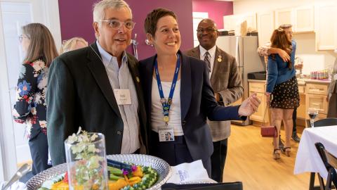 two people smile at a party