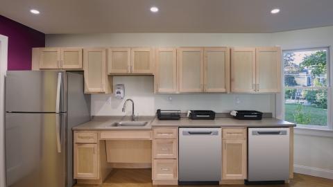 a view of a kitchen area with sink and appliances