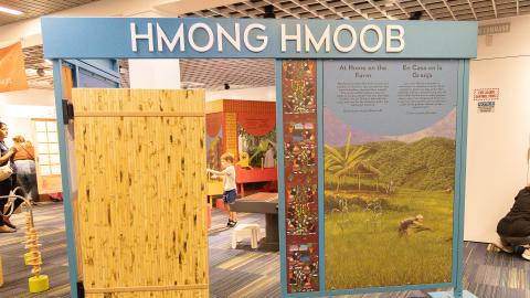 a small replica of a home facade labeled "HMONG HMOOB"